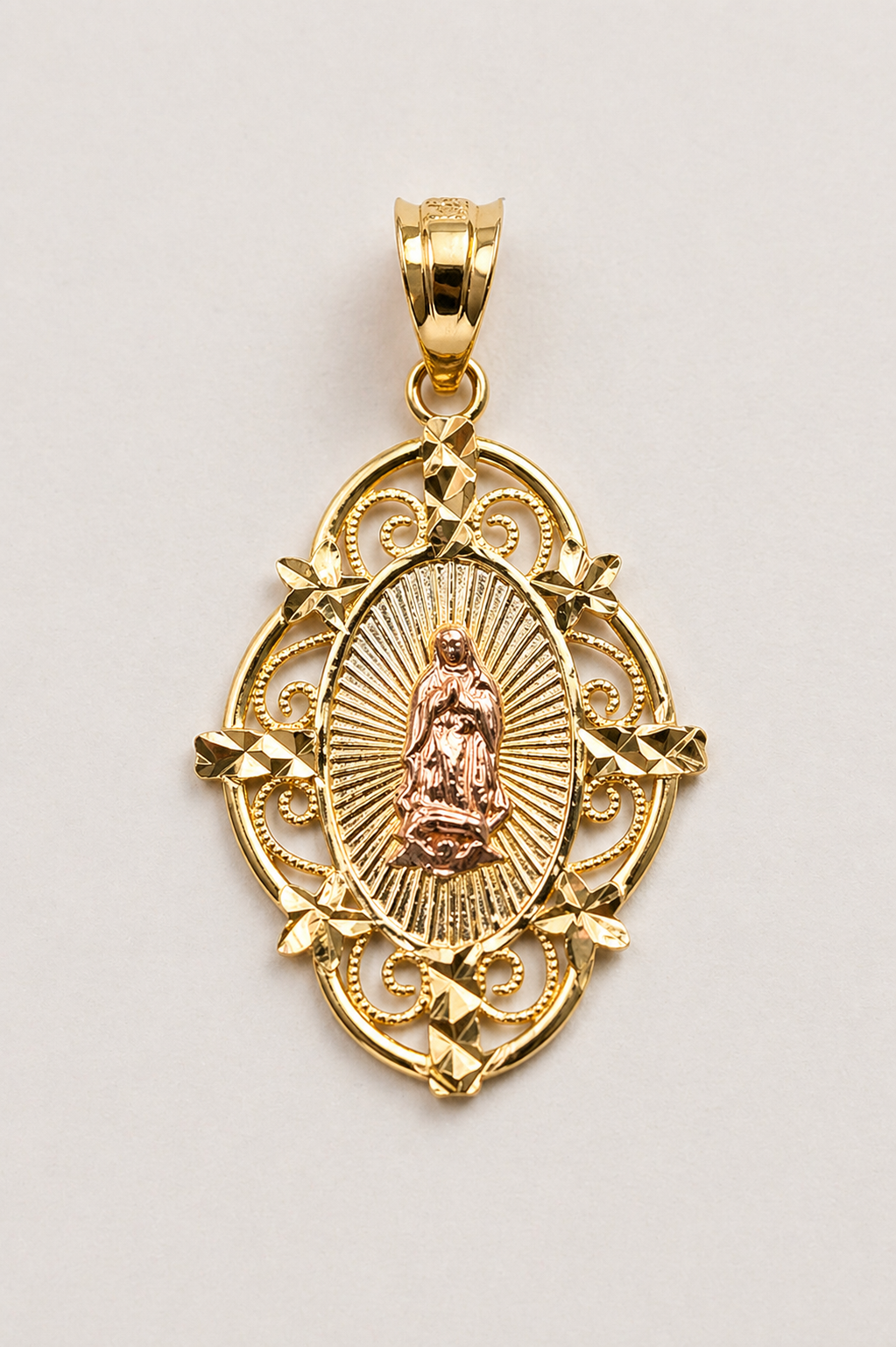 Gold pendant with religious design on a light gray background