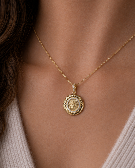 Gold necklace with a round pendant worn by a person