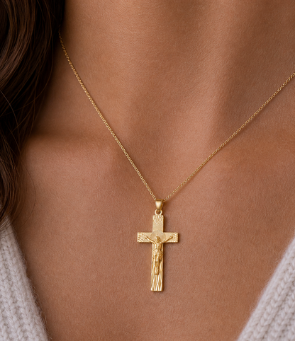 Gold crucifix necklace on a person's neck