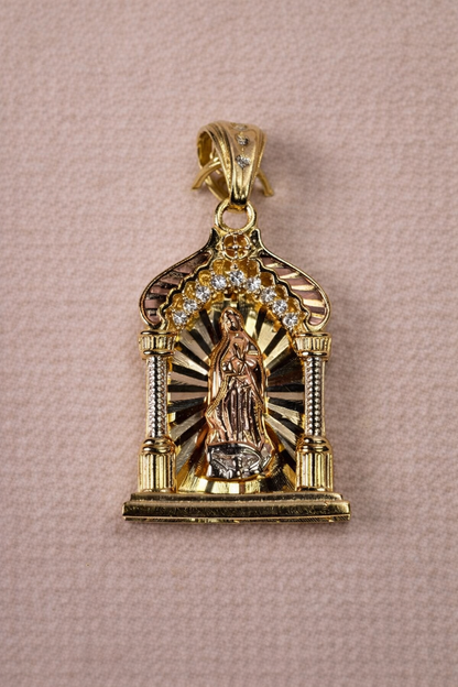 Gold pendant with religious design on a pink background