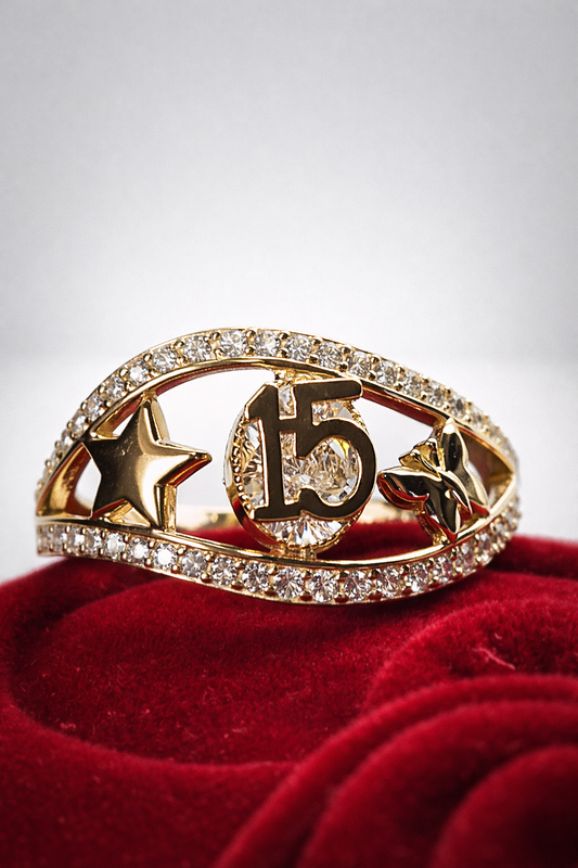 Gold ring with star and number design on a red cushion against a white background